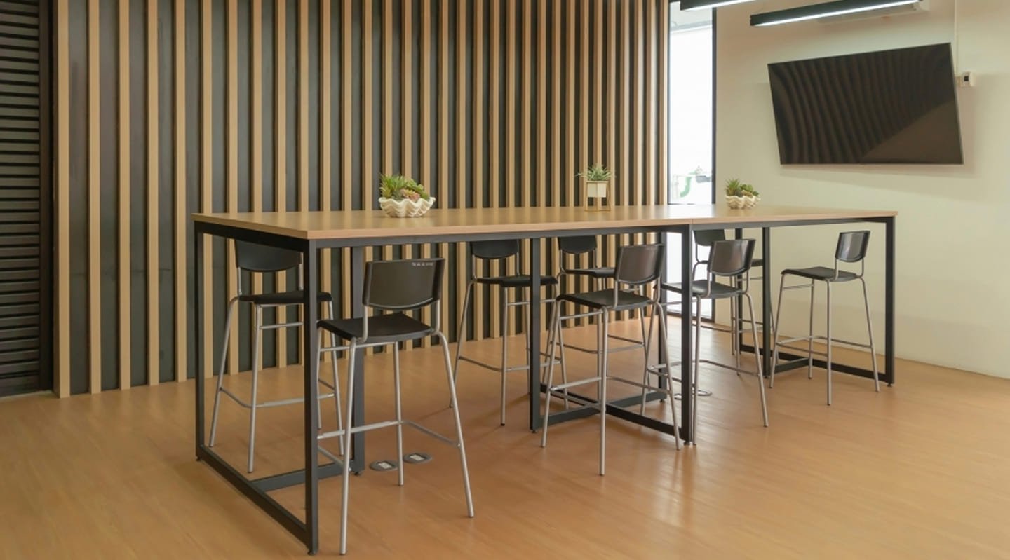 Commercial breakout area Scoresby - vertical timber slat accent wall, linear LED pendant lights, high bar tables and wall-mounted display screen