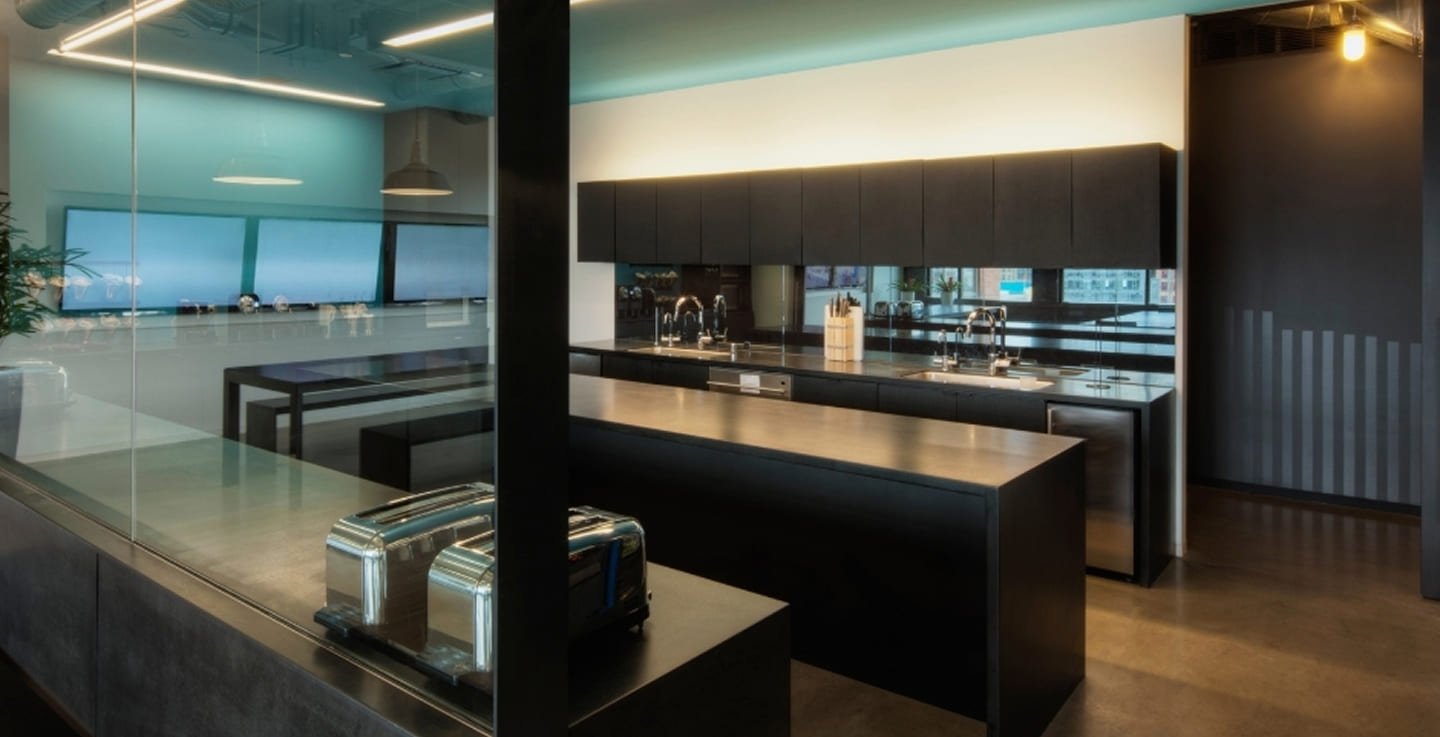 Commercial kitchen fit-out Belgrave - dark cabinetry, stainless steel benchtops, linear pendant lights, glass partition and teal feature ceiling