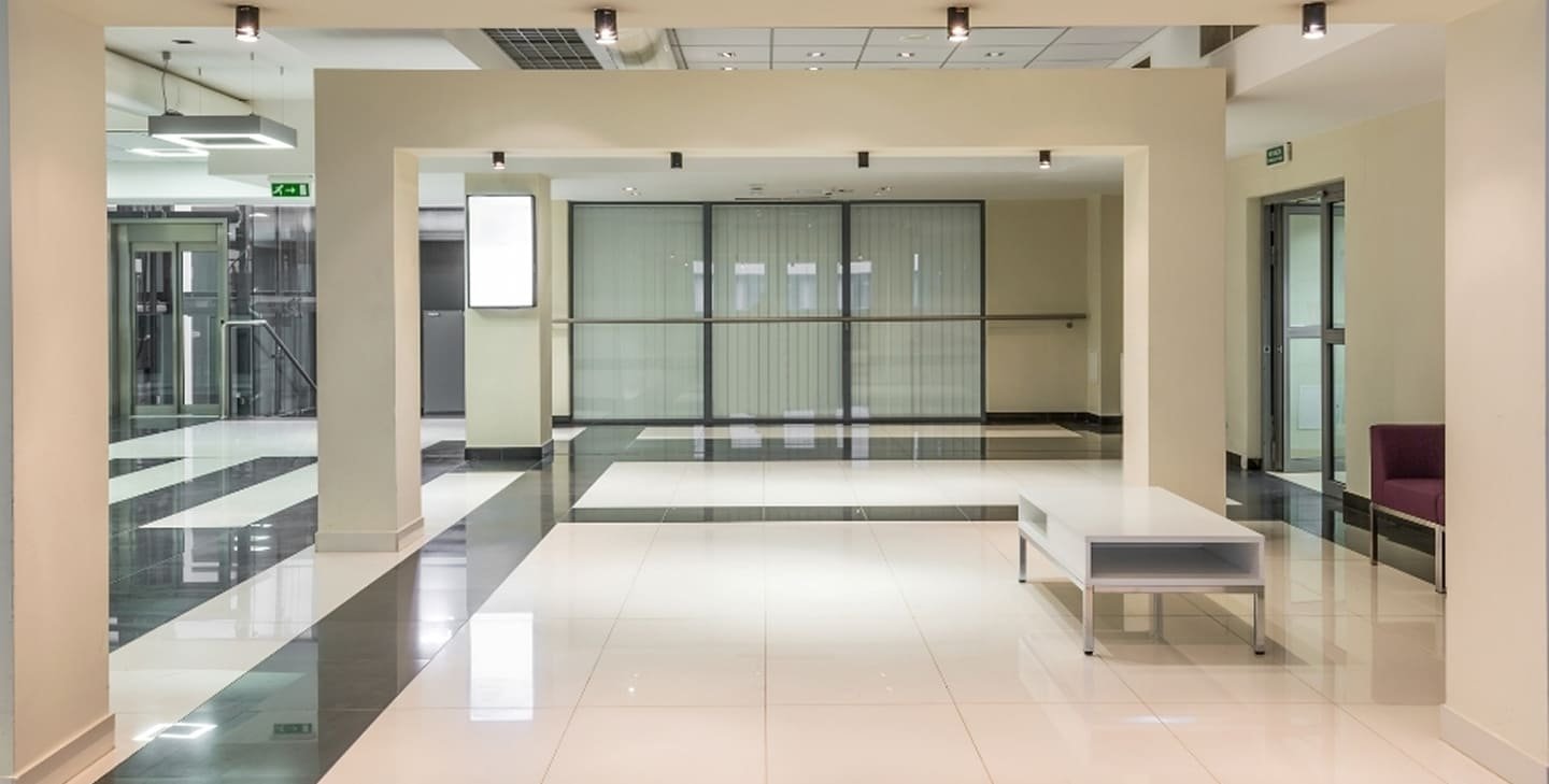 Commercial lobby refurbishment Montrose - polished tile flooring, glass partitions, recessed lighting and open layout