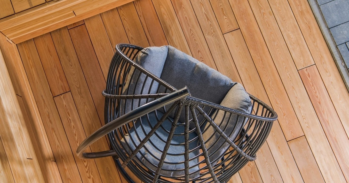 Hardwood timber deck detail Mountain Gate - oiled Merbau decking boards with outdoor chair and integrated planter box