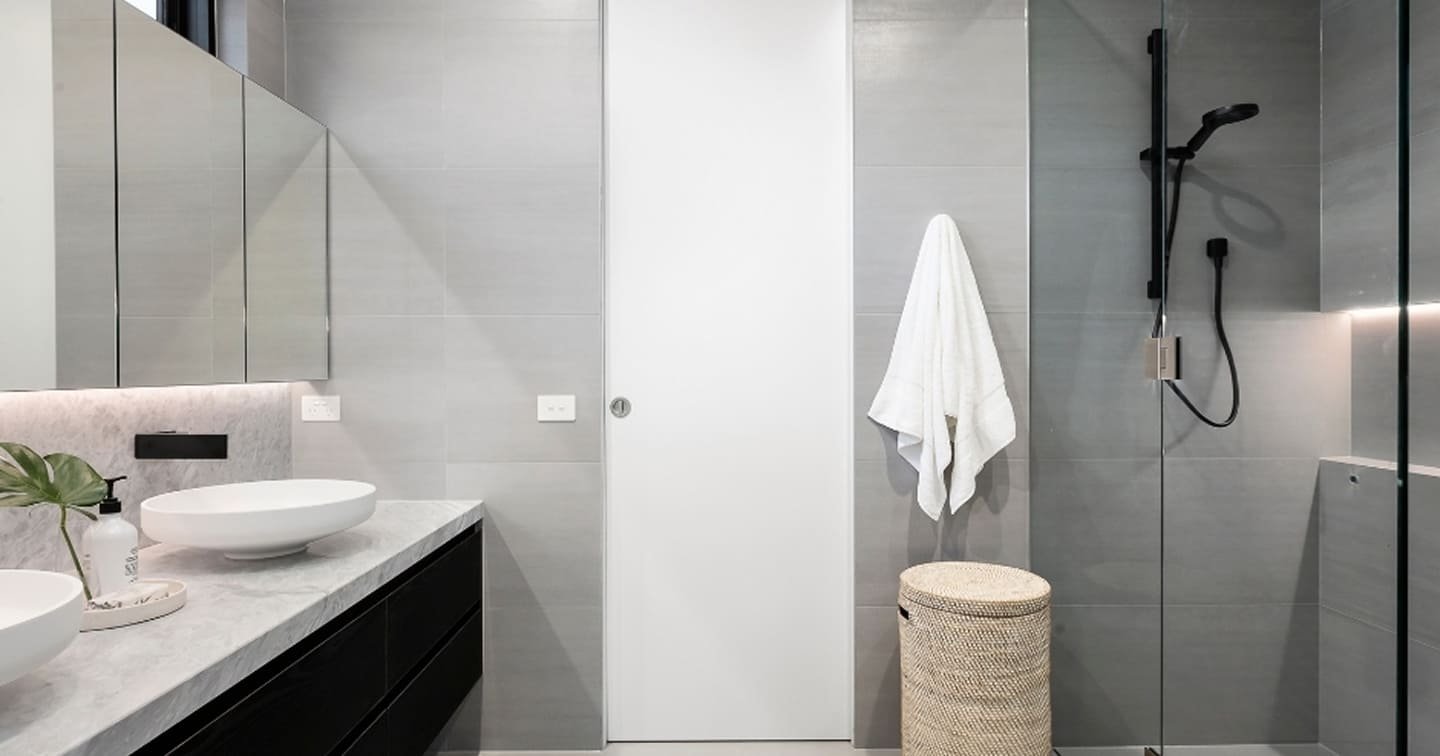 Minimalist Ensuite with Dark Vanity and Marble Top Bg Img