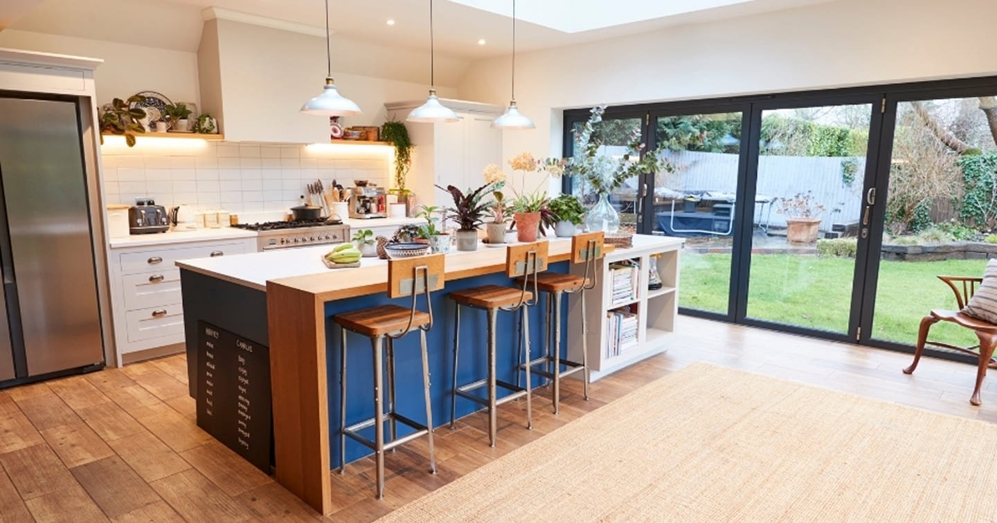 Open plan kitchen living extension Mooroolbark - island bench with seating, skylight glazing, bifold doors to garden and engineered timber flooring