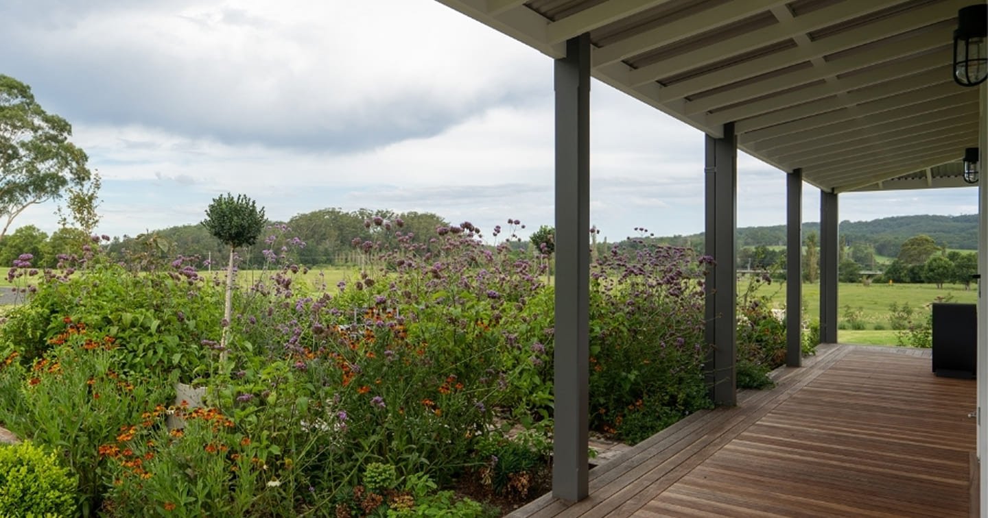 Covered verandah deck Tecoma - hardwood timber decking, steel pergola posts, garden border and Dandenong Ranges views
